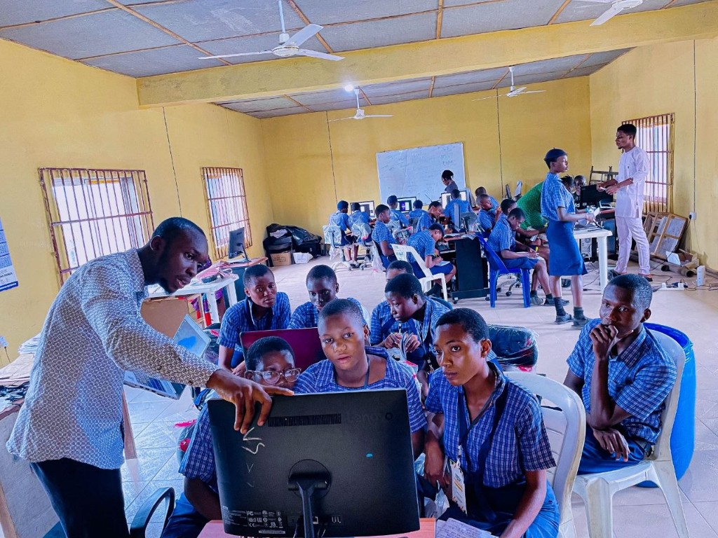 FOSPI girls UI/UX cohort at Akim Secondary School presenting finished screens on demo day