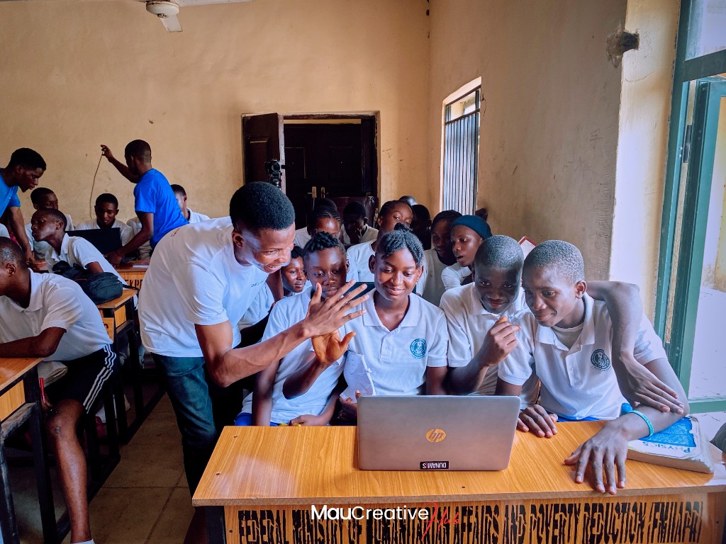 School outreach day in Akpabuyo, Cross River State, with students learning at laptops